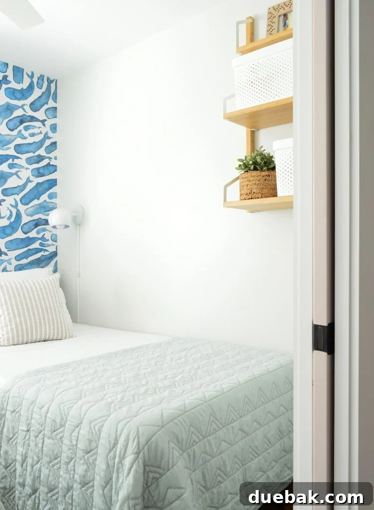 Duplex bonus bedroom with blue whale mural, pocket door, and practical wall shelf.