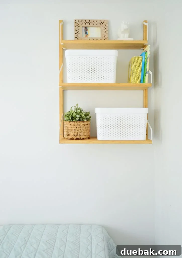 Detail of the wall shelf in the duplex bonus bedroom, showing baskets and decorative items.