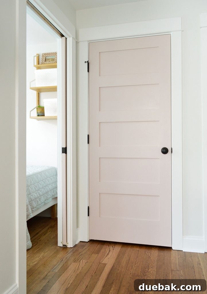 Duplex hallway linen closet with a closed white truffle door.