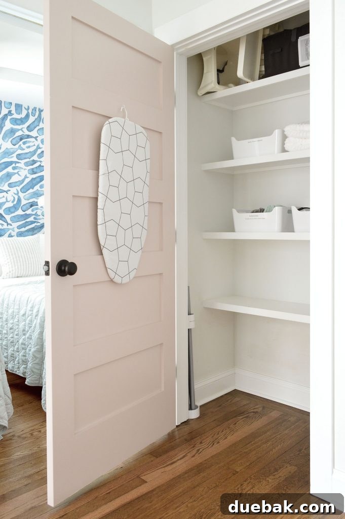 Duplex hallway linen closet with open organization, showing guest amenities.