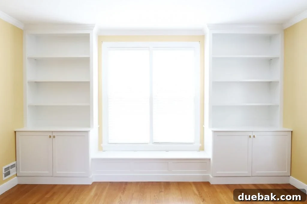 Curated Bookshelf Styling 4 After photo of living room with custom built-in bookshelves and bench.