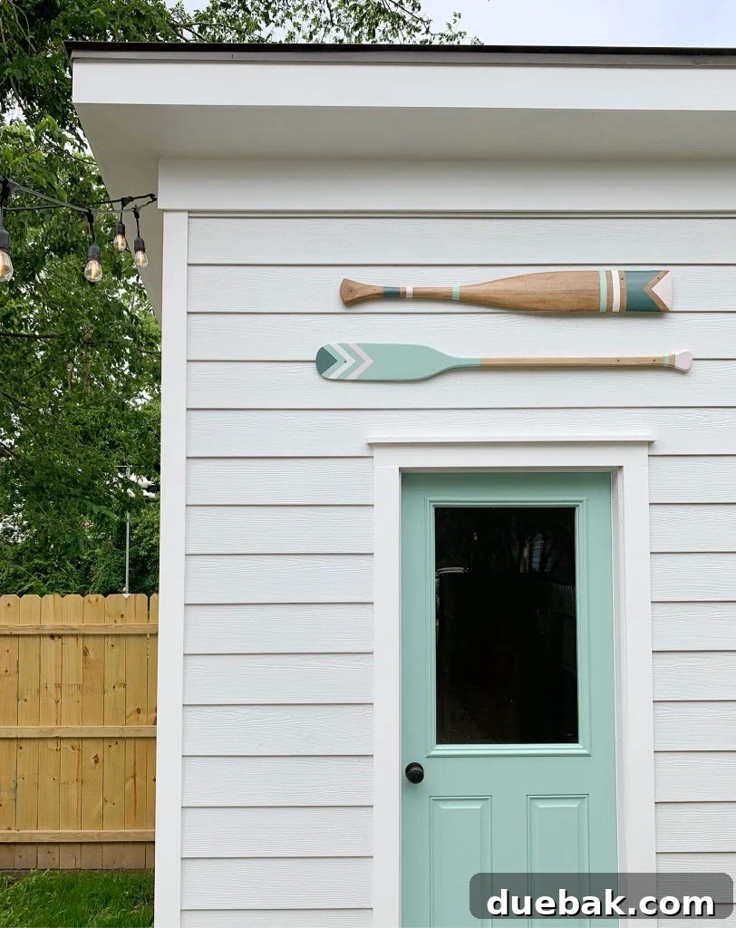 Close-up of the shed with custom-painted decorative oars, adding a unique coastal touch to the duplex backyard and enhancing its rental appeal.