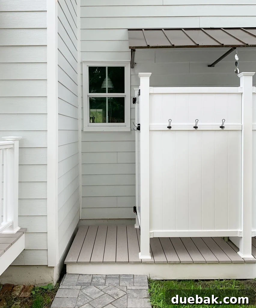 Close-up of the outdoor shower featuring a no-rot composite surround and proper Azek drainage system, all protected by a functional awning.