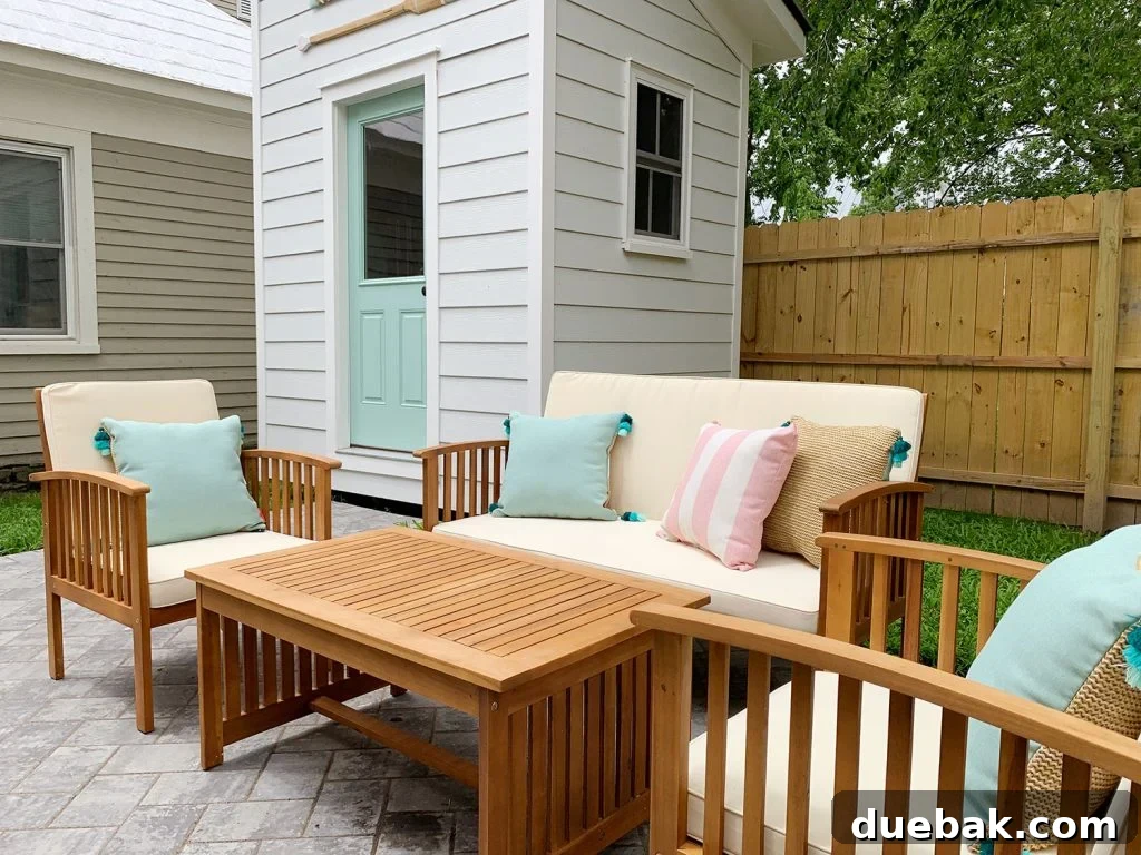 View of the left side backyard, with the neighbor's shed in the background providing natural privacy for the duplex units.