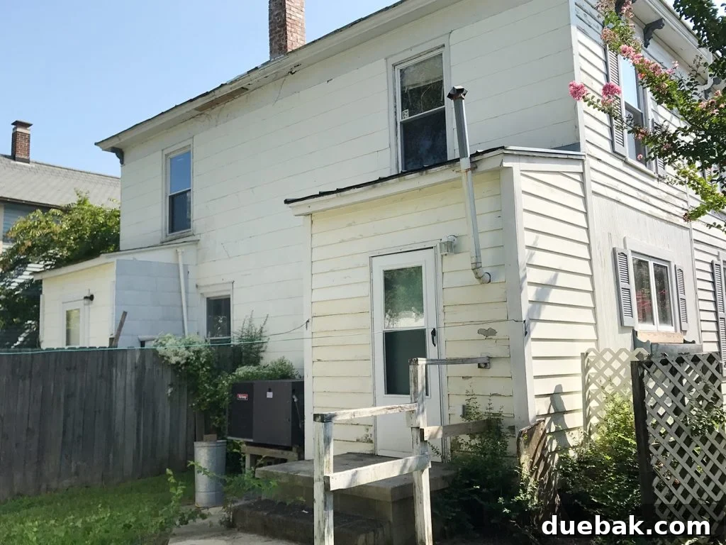 Before photo showing the old, inconvenient placement of AC units at the back of the duplex, prior to the installation of outdoor showers.
