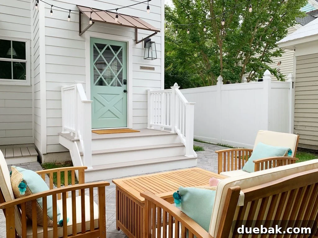 Updated back steps and railings of the duplex, constructed with durable, low-maintenance composite material, enhancing the exterior's longevity.