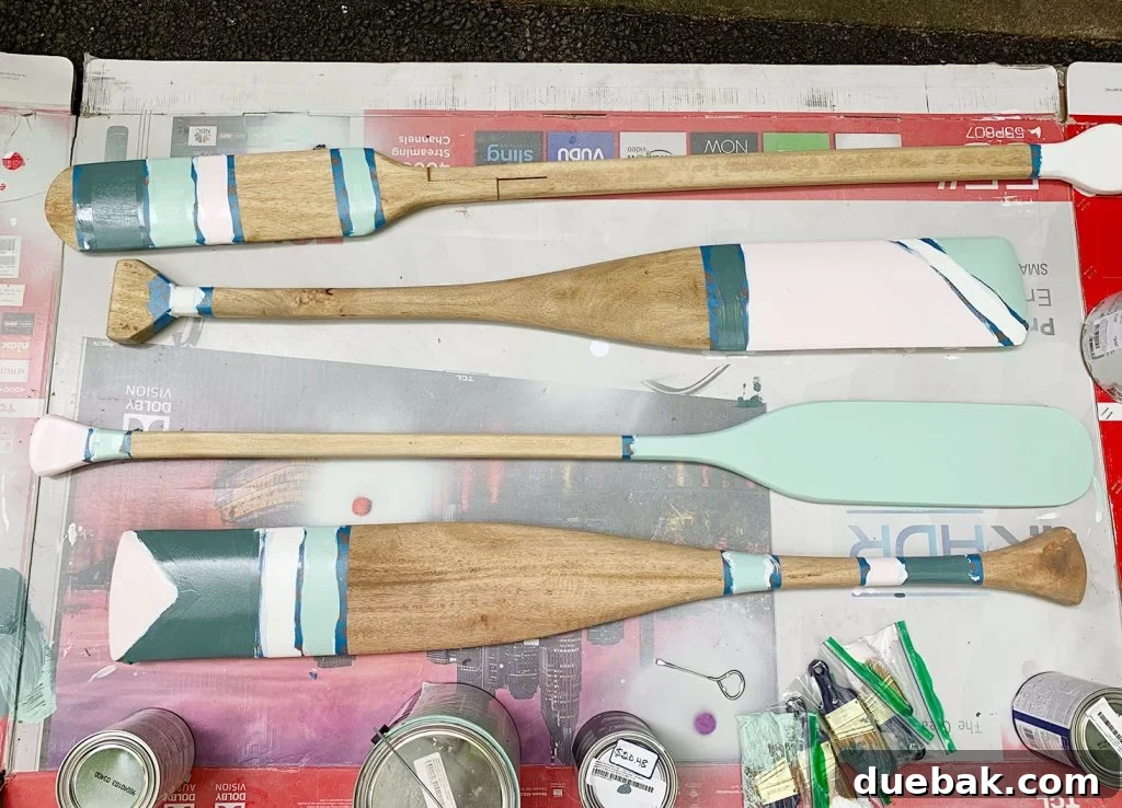 Decorative oars in various stages of painting