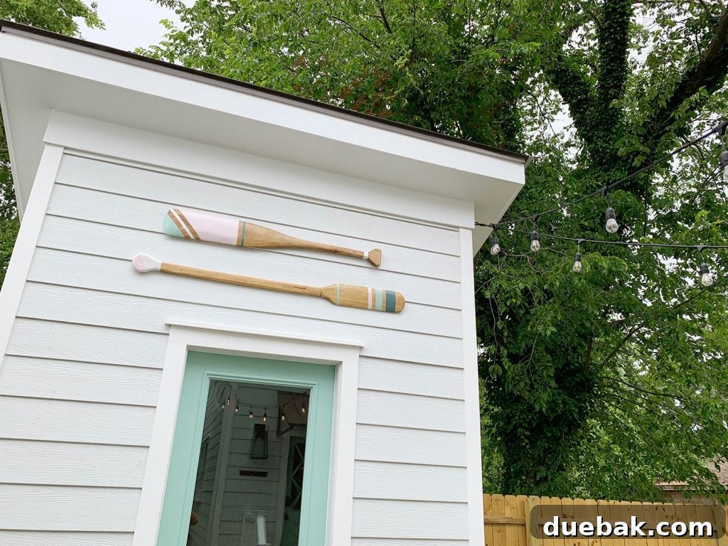 Empty space above a shed door where decorative oars would eventually hang