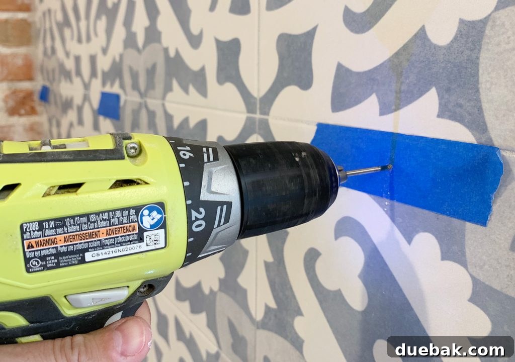 Drilling Through Tile Backsplash Using Marked Spot With Painters Tpae