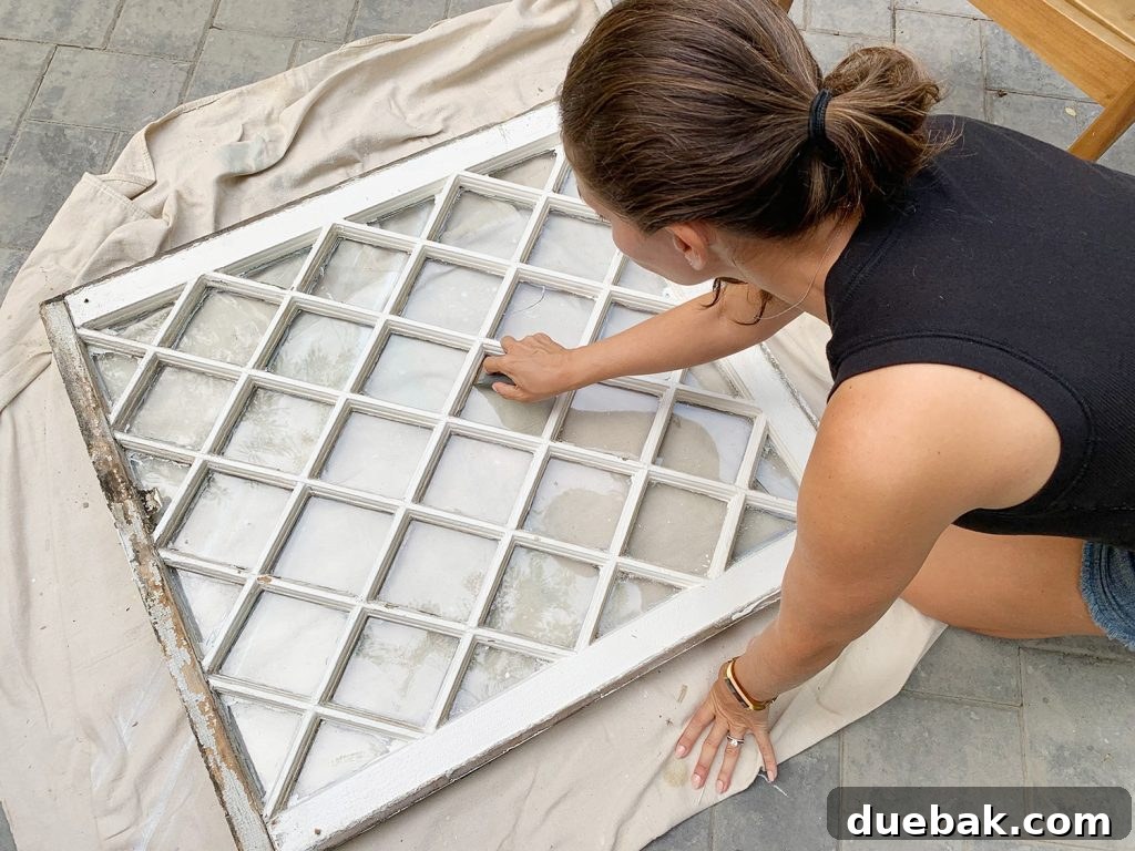 Sherry Scraping Glass Window Clean Before Hanging