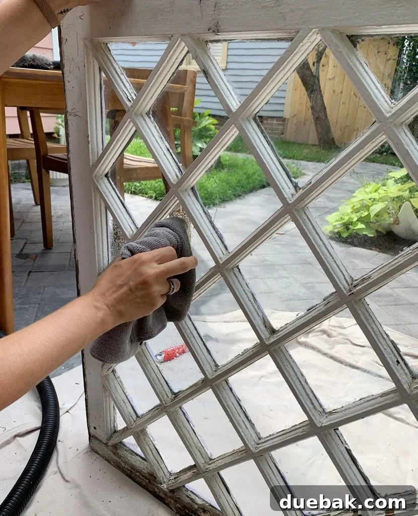 Wiping Glass Clean On Old Diamond Pane Window