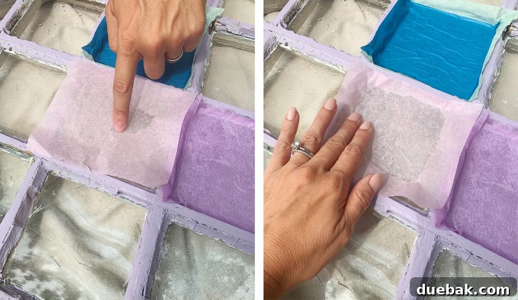 Pressing Sheet Of Pink Tissue Paper Onto Glass Pane