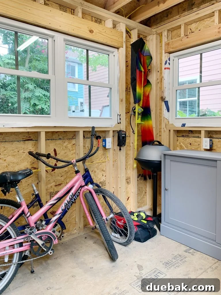 Taming the Beach House Shed 12 Shed interior with windows, leaning bikes, and an electric grill