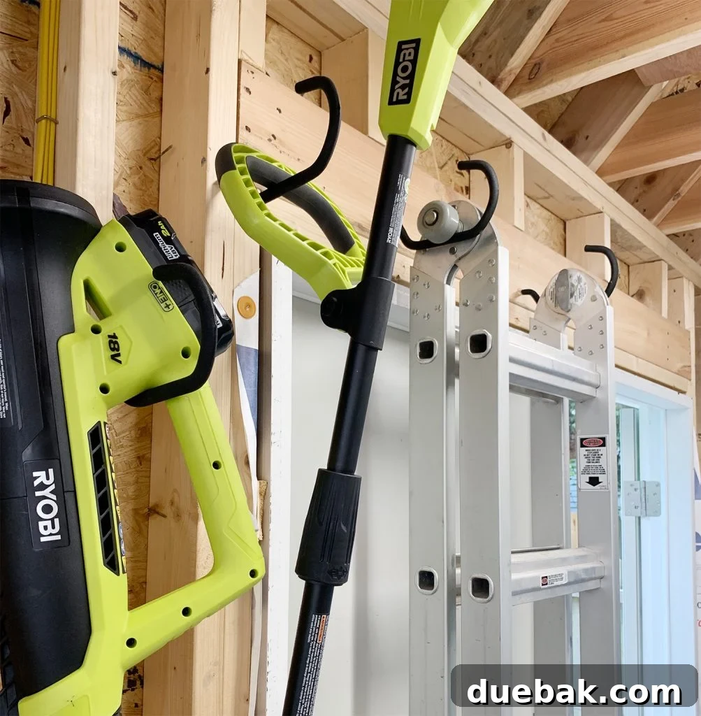 Taming the Beach House Shed 16 Heavy duty hooks holding a leaf blower and weed trimmer