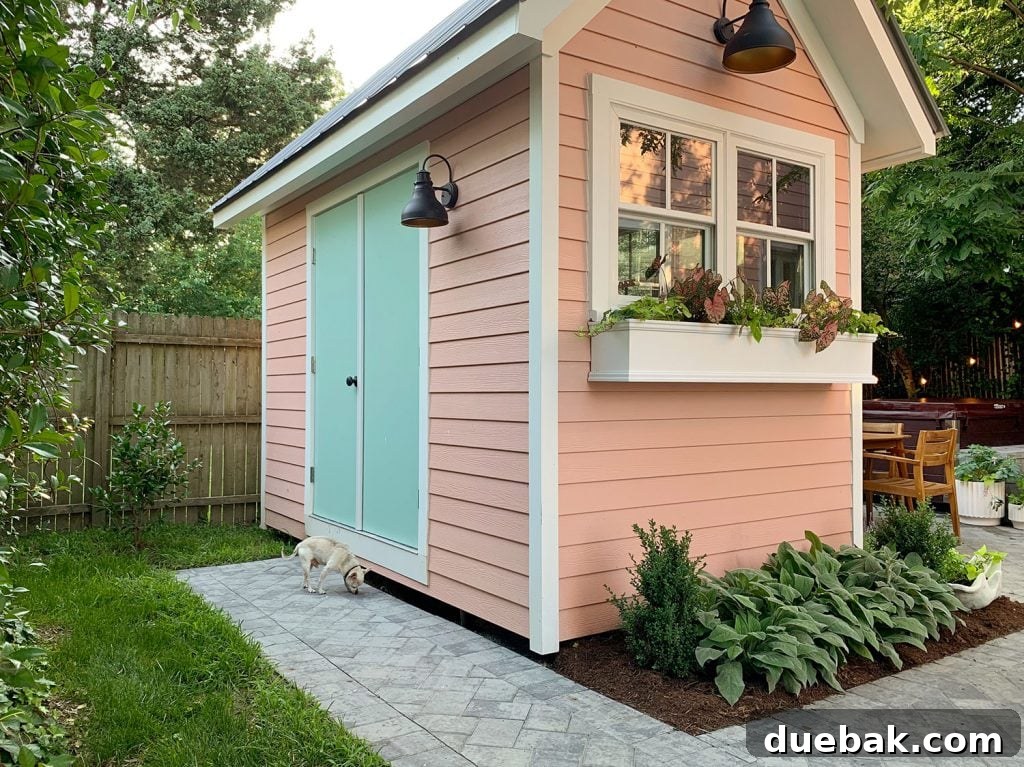 Taming the Beach House Shed 18 Exterior view of the pink beach house shed with blue-green doors