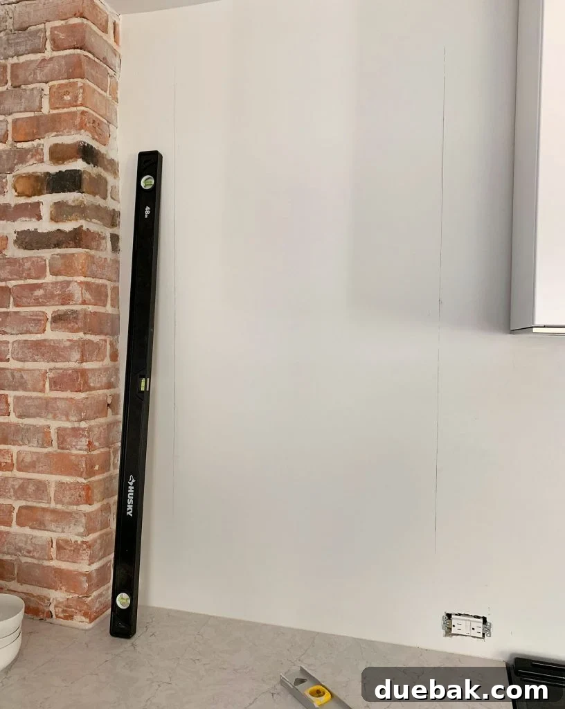Long Level Used To Mark Vertical Lines On Wall