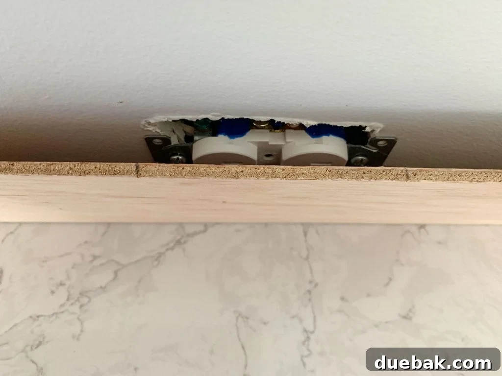Panel Marked In Front Of Electrical Outlet