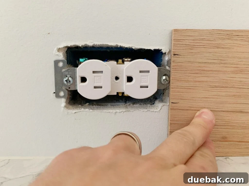 Height Of Electrical Outlet Marked Using Scrap Wood Panel