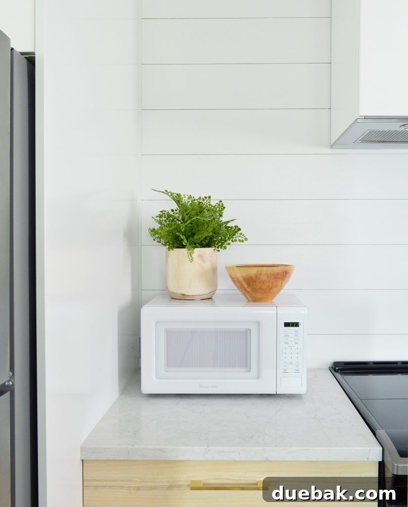 Detail Of Planked Wall In Duplex Kitchen With Counter Microwave