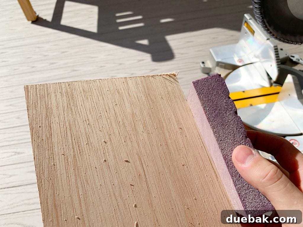 Sanding Rough Edges Of Wood Panel Strip Using Sanding Block