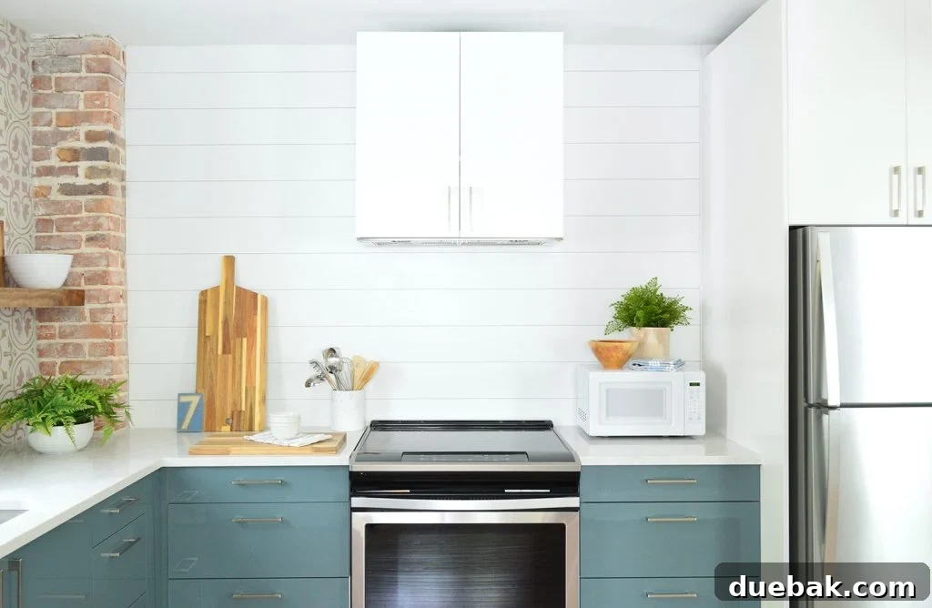 Ikea Kitchen Pricing Deconstructed 10 The organized cooking area of the duplex kitchen, featuring a stainless steel range, exhaust hood, and a built-in microwave, with stylish utensil holder.