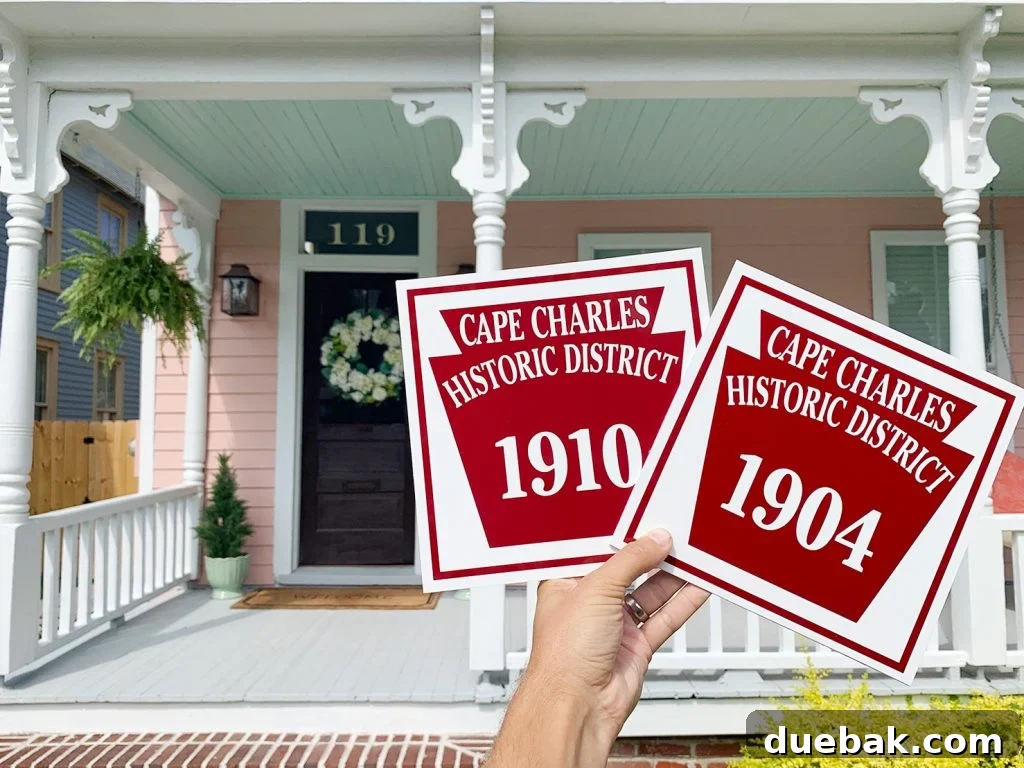 The Pink House Unveiling Its Unexpected History 2 A charming historic home with a new front door color and a freshly installed historic district plaque.