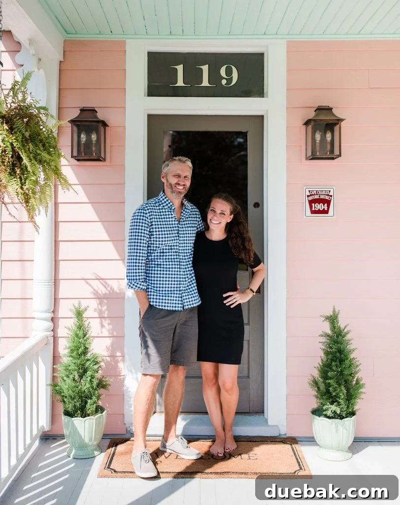 The Pink House Unveiling Its Unexpected History 12 The beach house exterior featuring the new historic plaque and refreshed porch decor, taken by a professional photographer.
