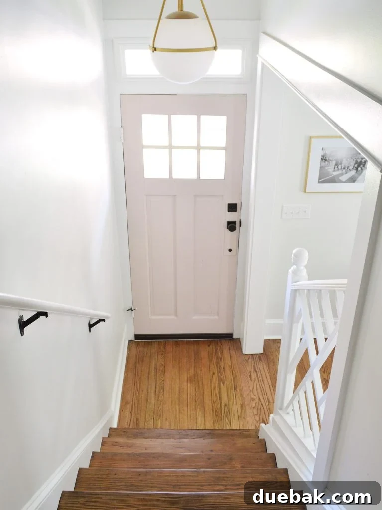 Hallway with a wooden door and light fixture