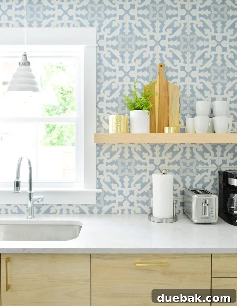 Wood Colored Opened Shelf Against Blue Tile Backsplash