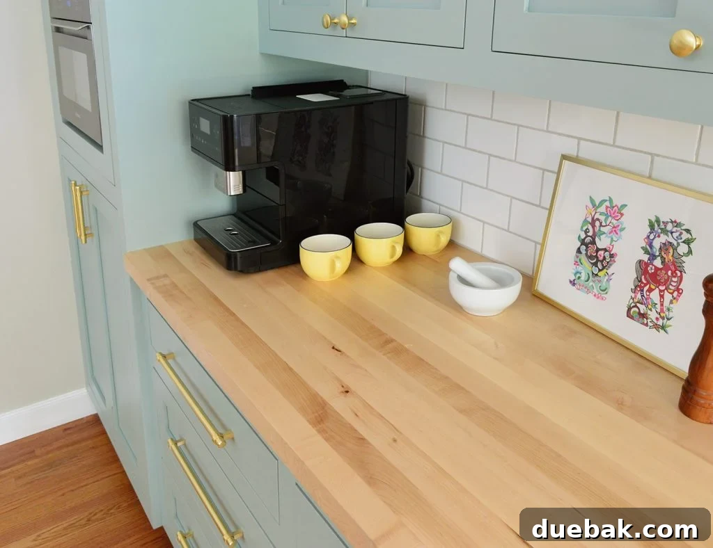 Elevate Your Kitchen Inset Doors for a Custom Cabinet Makeover 11 Butcher Block Countertop With Subway Tile Backsplash in Halcyon Green Blue Kitchen