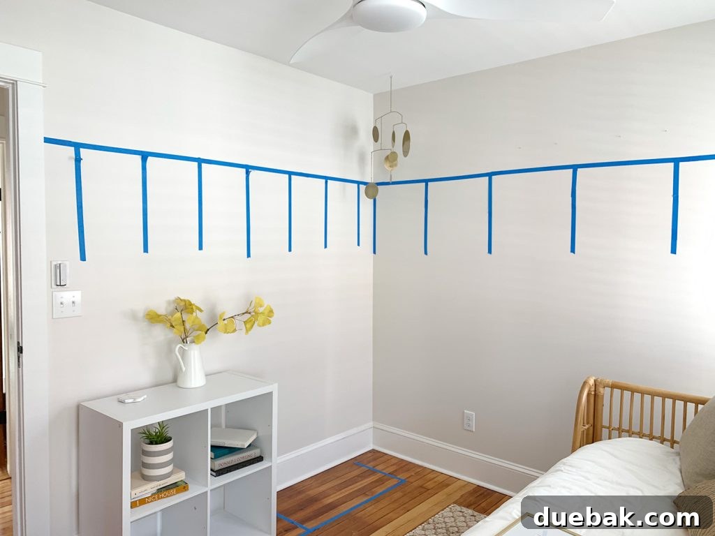 4 Smart Decor Hacks for an Effortless Home Transformation 18 Wall with painter's tape showing height for board and batten, ready for wallpaper
