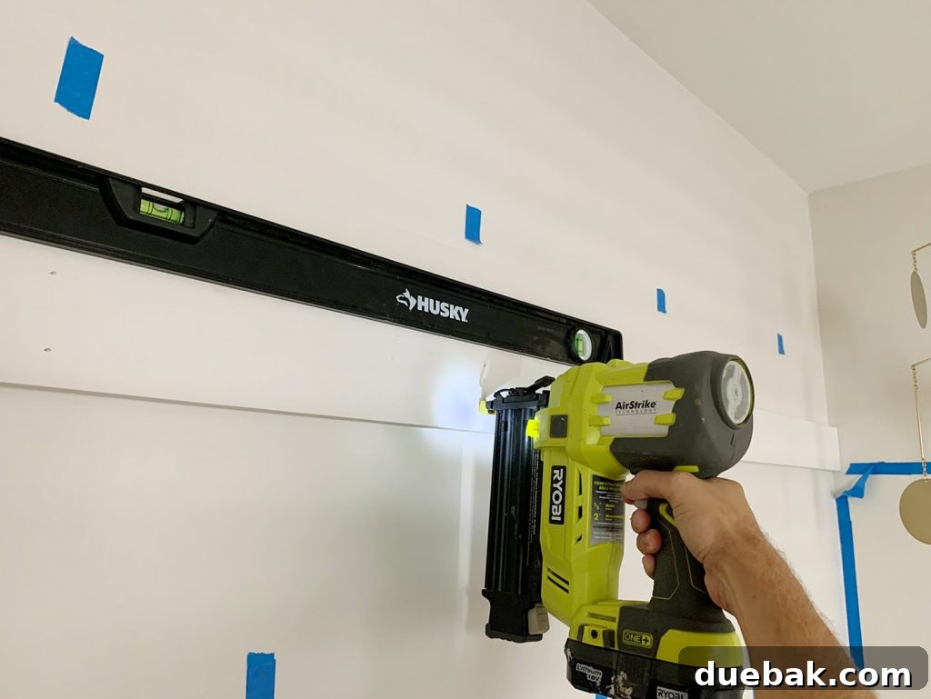 Board and Batten Made Easy 9 Using Nail Gun To Install Top Rail Of Board And Batten