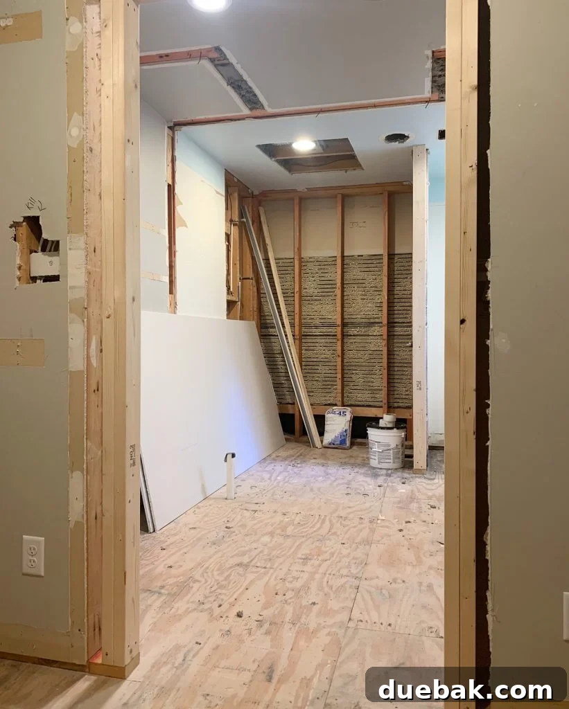 Simple Hacks for a Smoother Day 2 Bathroom renovation progress showing raw materials and framing for a new closet door.