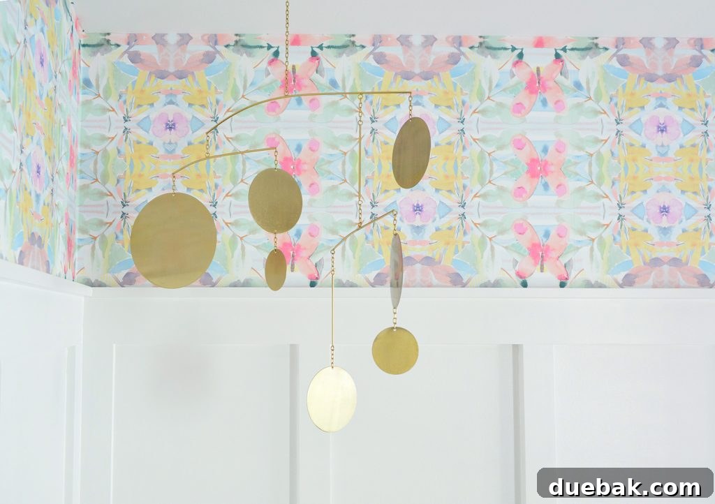 Textural Tides: Wallpaper and Board and Batten in a Beach Bedroom 15 Detail shot of the peel and stick wallpaper and a brass mobile