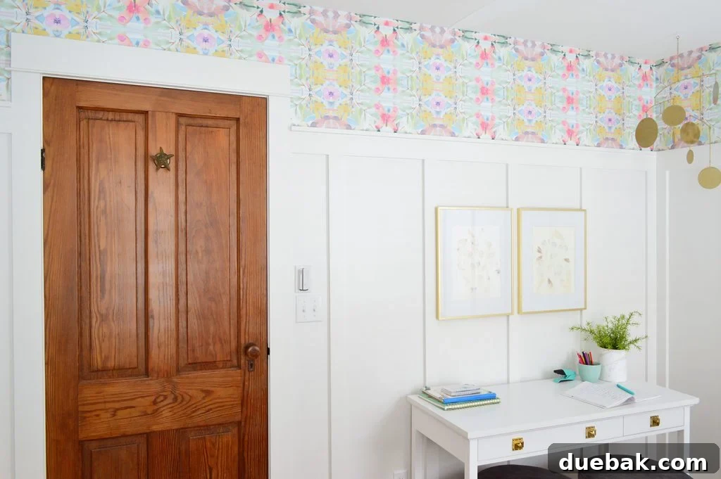 Textural Tides: Wallpaper and Board and Batten in a Beach Bedroom 19 Wood door in bedroom with colorful peel and stick wallpaper above board and batten