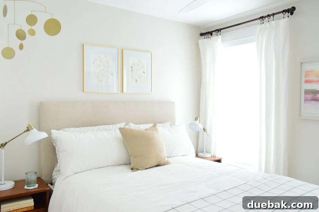 Textural Tides: Wallpaper and Board and Batten in a Beach Bedroom 3 Before image of the middle bedroom with a large queen bed and minimal decor