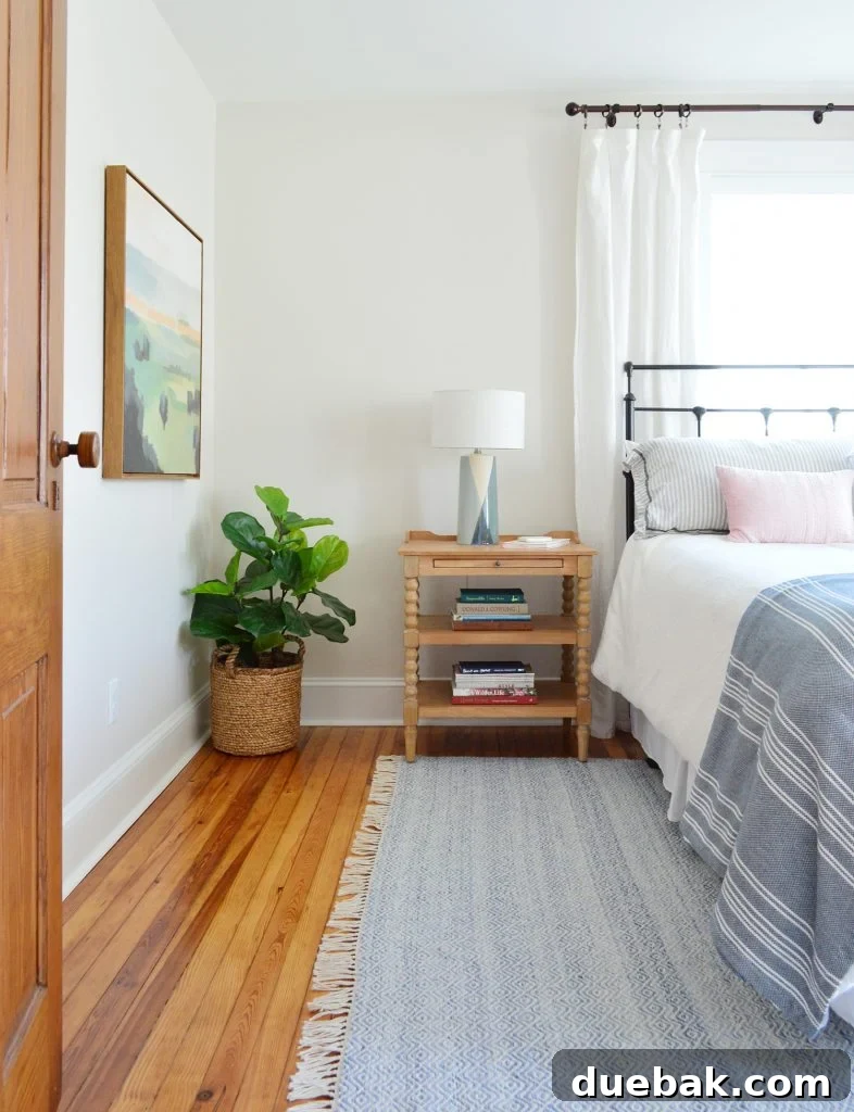 Textural Tides: Wallpaper and Board and Batten in a Beach Bedroom 8 Beach House Front Bedroom with a blue rug and wooden nightstand