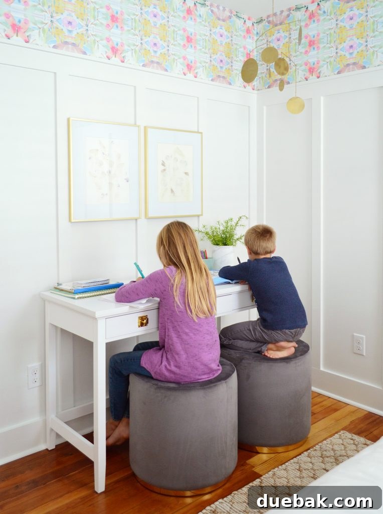 Textural Tides: Wallpaper and Board and Batten in a Beach Bedroom 10 Kids seated on stools at a writing desk in the beachy bedroom