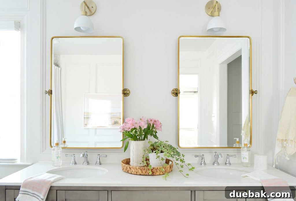 5 Ways to Keep Your Cool During Renovation 13 Two gold pivot mirrors over gray bathroom double vanity