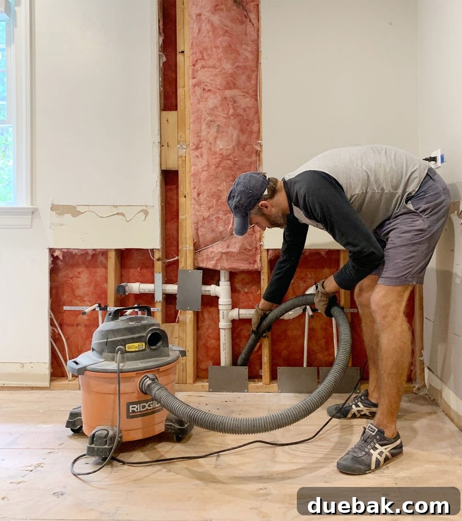 5 Ways to Keep Your Cool During Renovation 16 John Using Shop Vac To Remove Dust During Bathroom Renovation