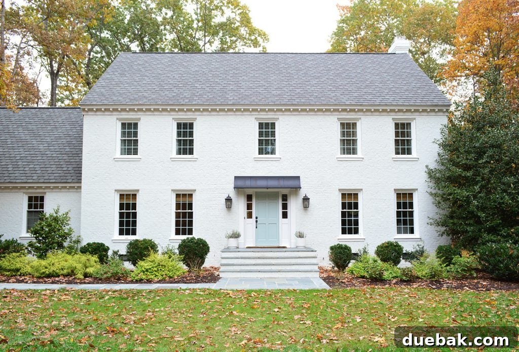 A wider view of the front entrance, showcasing the newly widened steps and bluestone path in harmony with the house.
