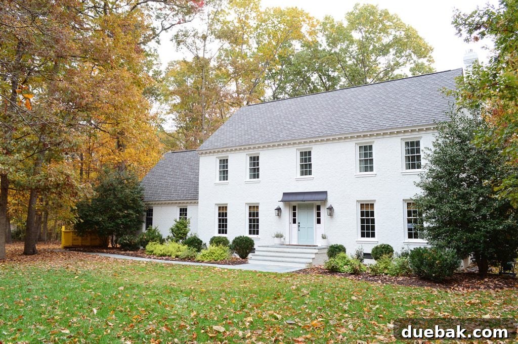 The white brick house exterior with a hint of upcoming changes, awaiting the installation of new shutters.