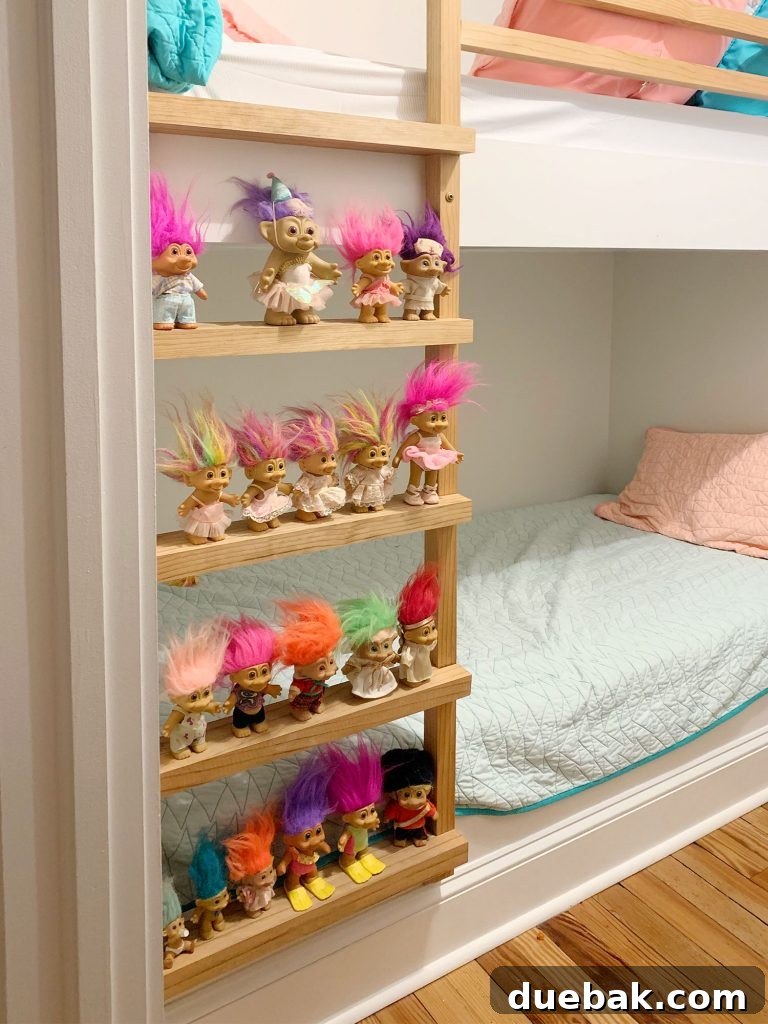 Collection of vintage troll dolls, including one with a birthday hat, evoking childhood nostalgia.