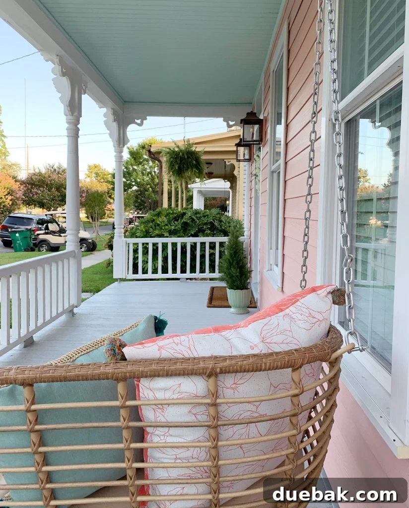 7 Beach House Renovations and the Story Behind Each Space 2 Beach house exterior with a white porch swing