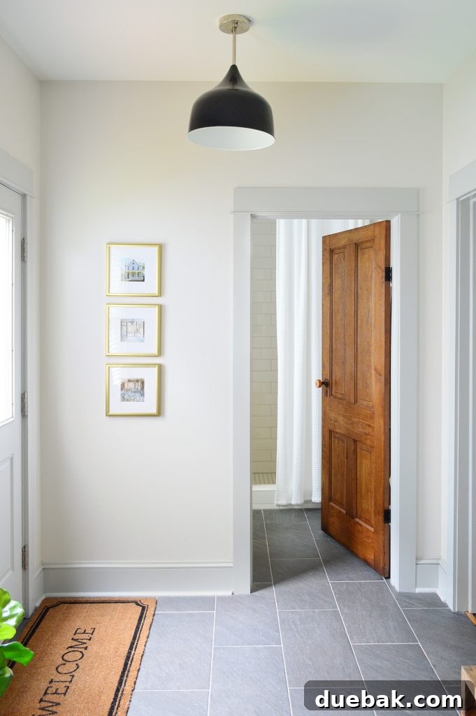 7 Beach House Renovations and the Story Behind Each Space 16 Original mudroom setup with limited hooks and framed photos