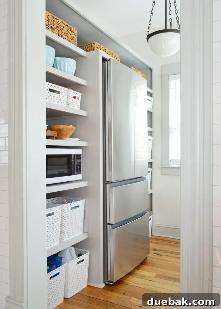 7 Beach House Renovations and the Story Behind Each Space 20 Updated walk-in beach house pantry with doubled storage baskets on shelves, showing improved organization