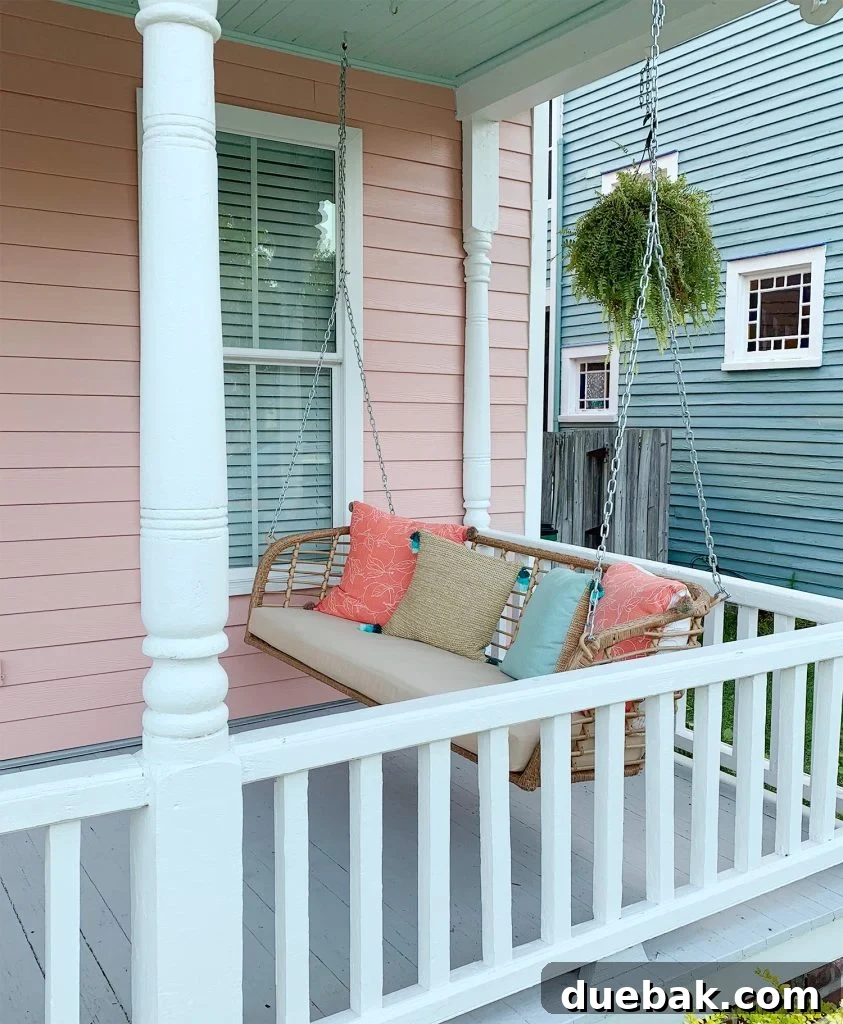 7 Beach House Renovations and the Story Behind Each Space 4 New, comfortable wicker-look porch swing on a front porch