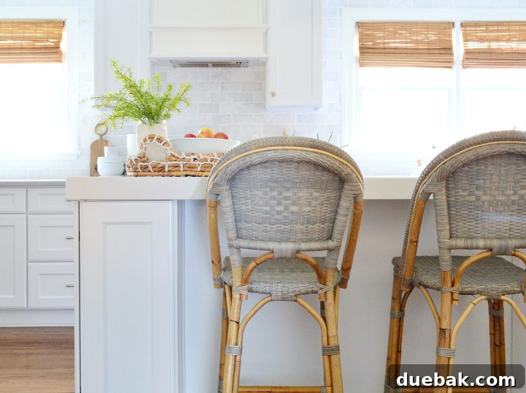 Modern kitchen with stylish woven counter stools providing comfortable seating at a kitchen island, complementing the overall design.