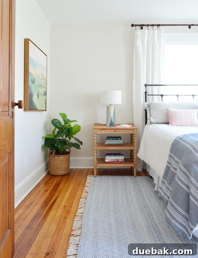 Beach House Front Bedroom With Blue Rug And Wooden Nightstand