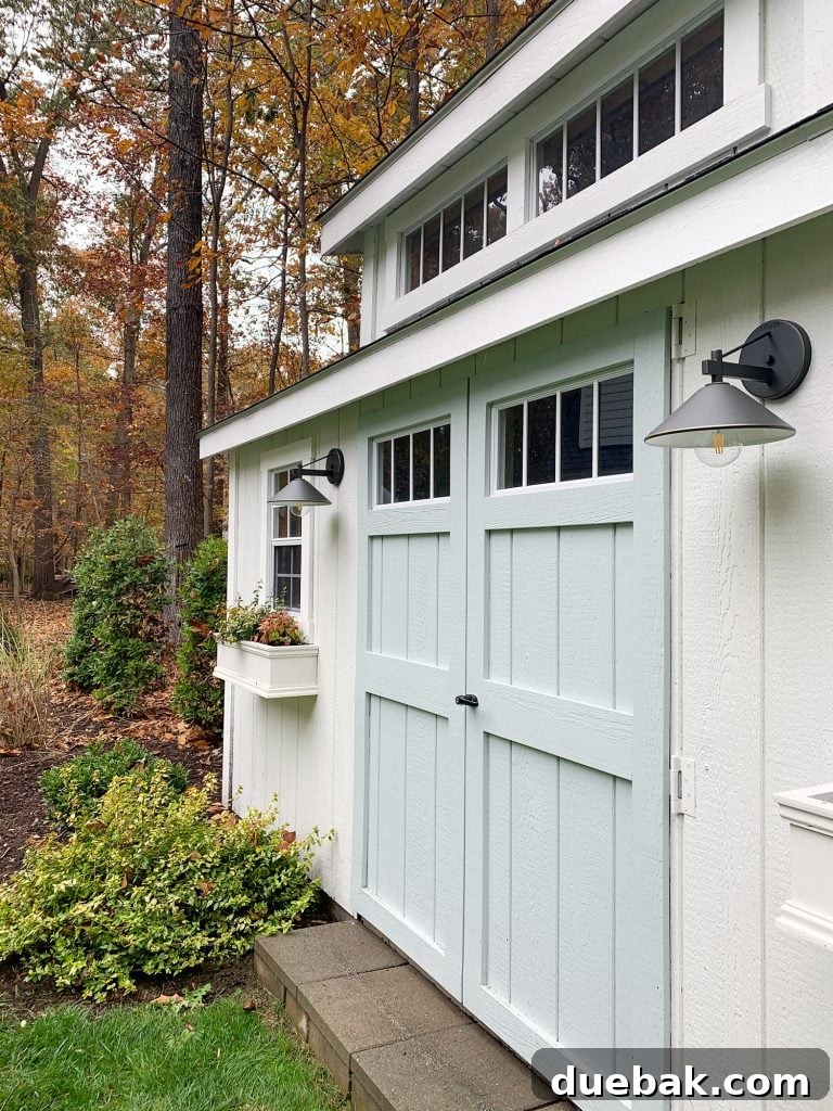 Shed Makeover: Paint and Window Boxes 2 Freshly painted white shed with new lights and a charming window box, perfectly matching the main house.